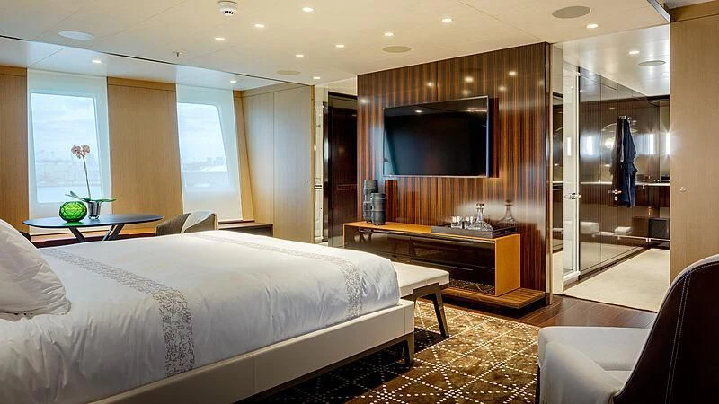 a room with a bed and a tv aboard HALO Yacht for Charter