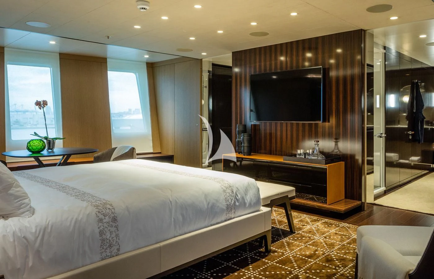 a hotel room with a bed and a tv aboard HALO Yacht for Charter