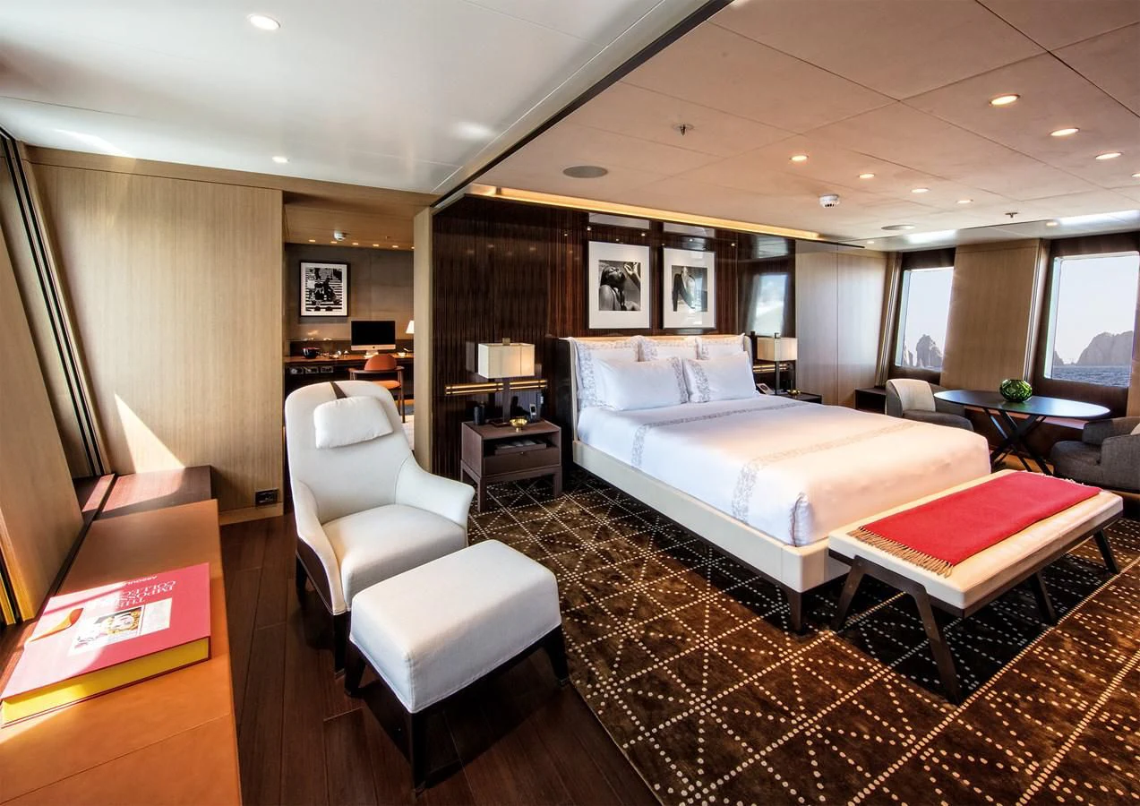 a hotel room with a bed and a couch aboard HALO Yacht for Charter
