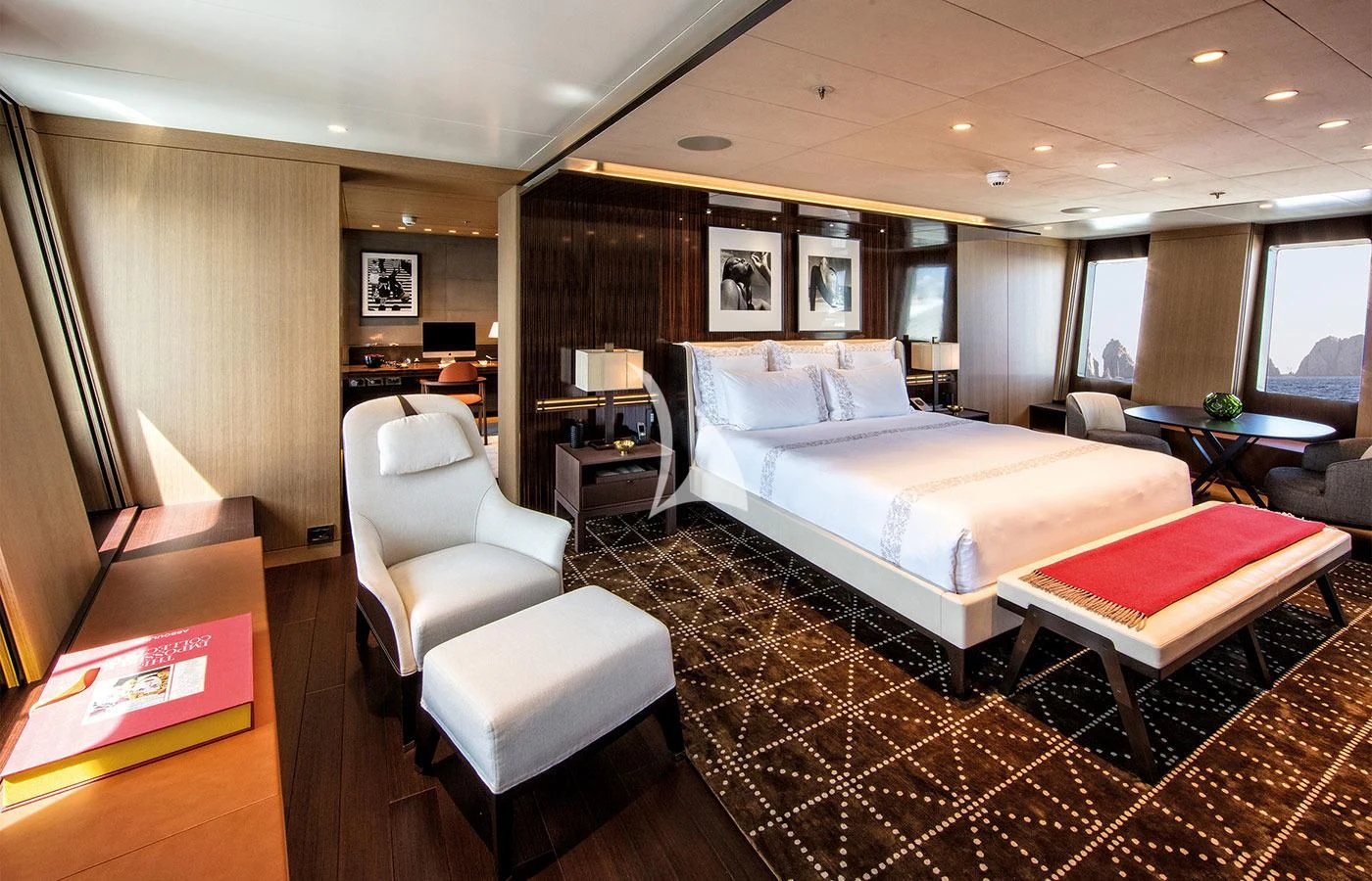 a hotel room with a bed and a desk aboard HALO Yacht for Charter