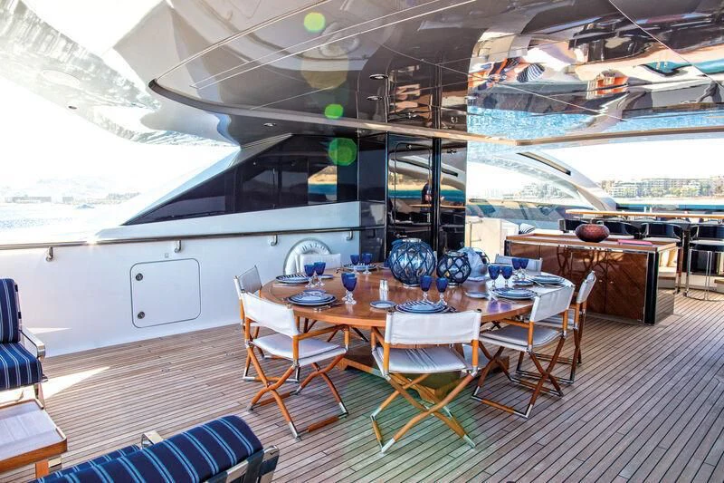 a room with tables and chairs aboard HALO Yacht for Charter