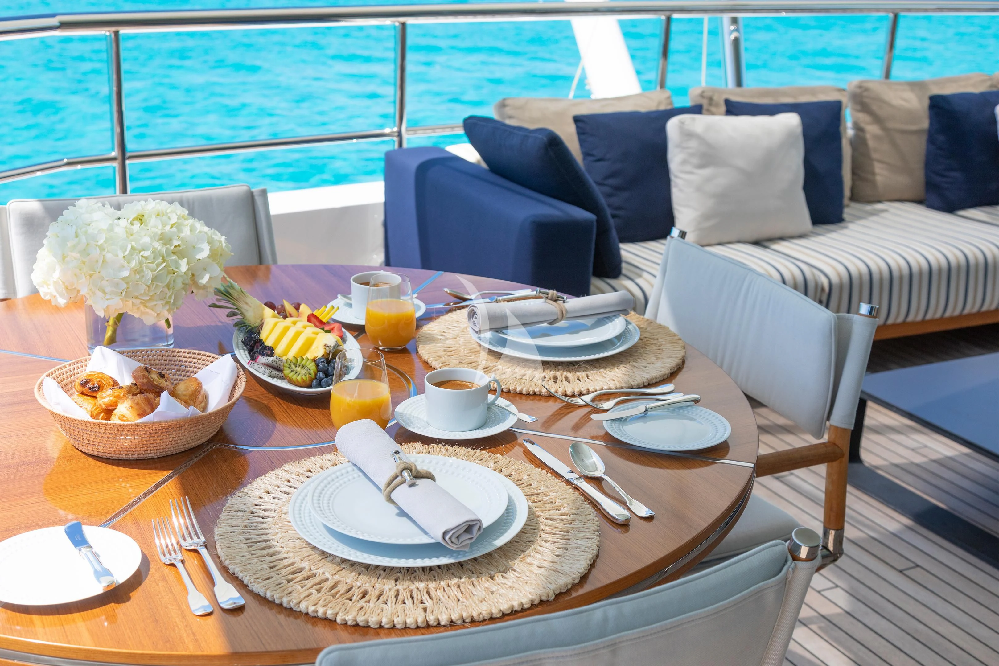 a table with plates and food on it aboard HALO Yacht for Charter