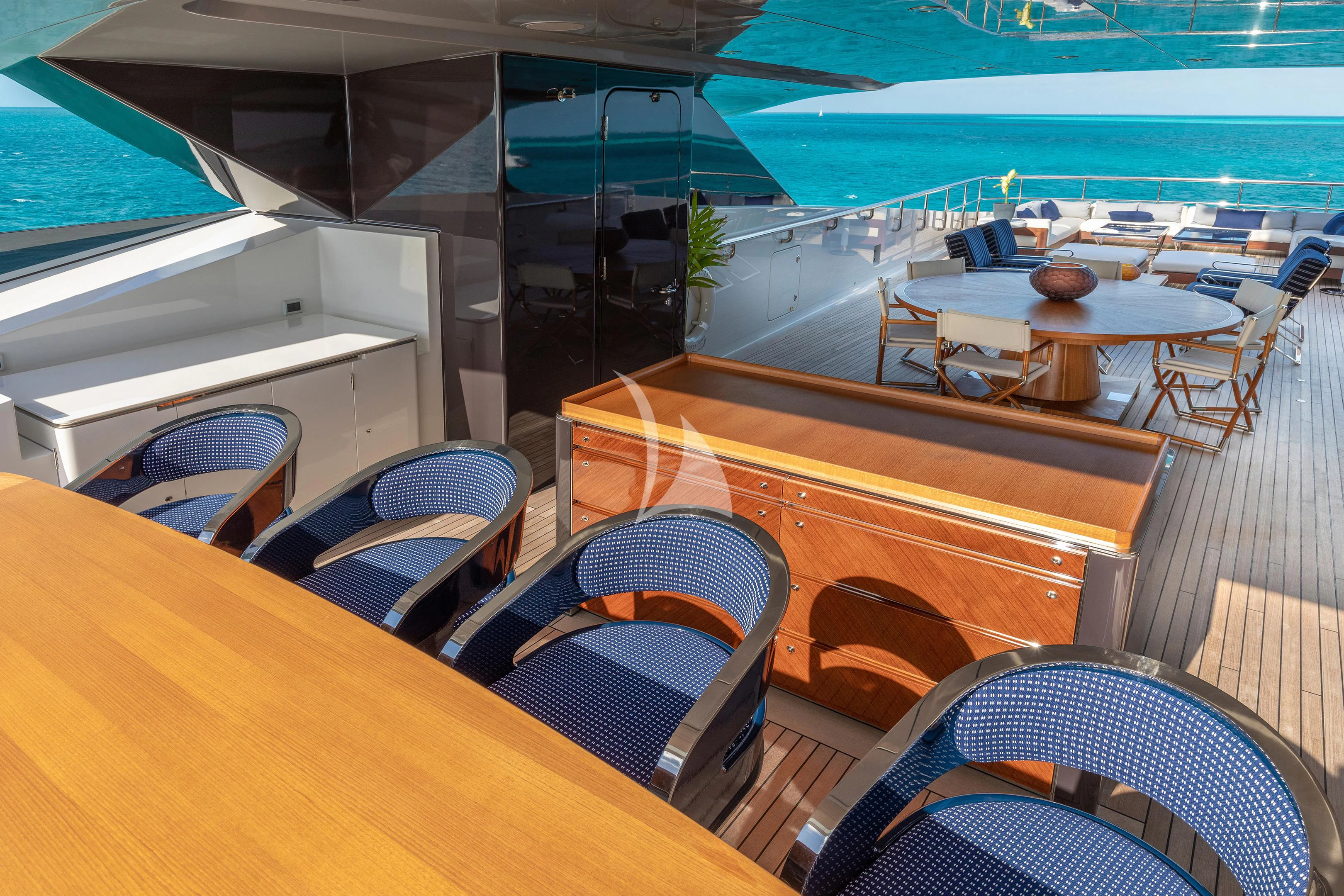 a room with tables and chairs aboard HALO Yacht for Charter
