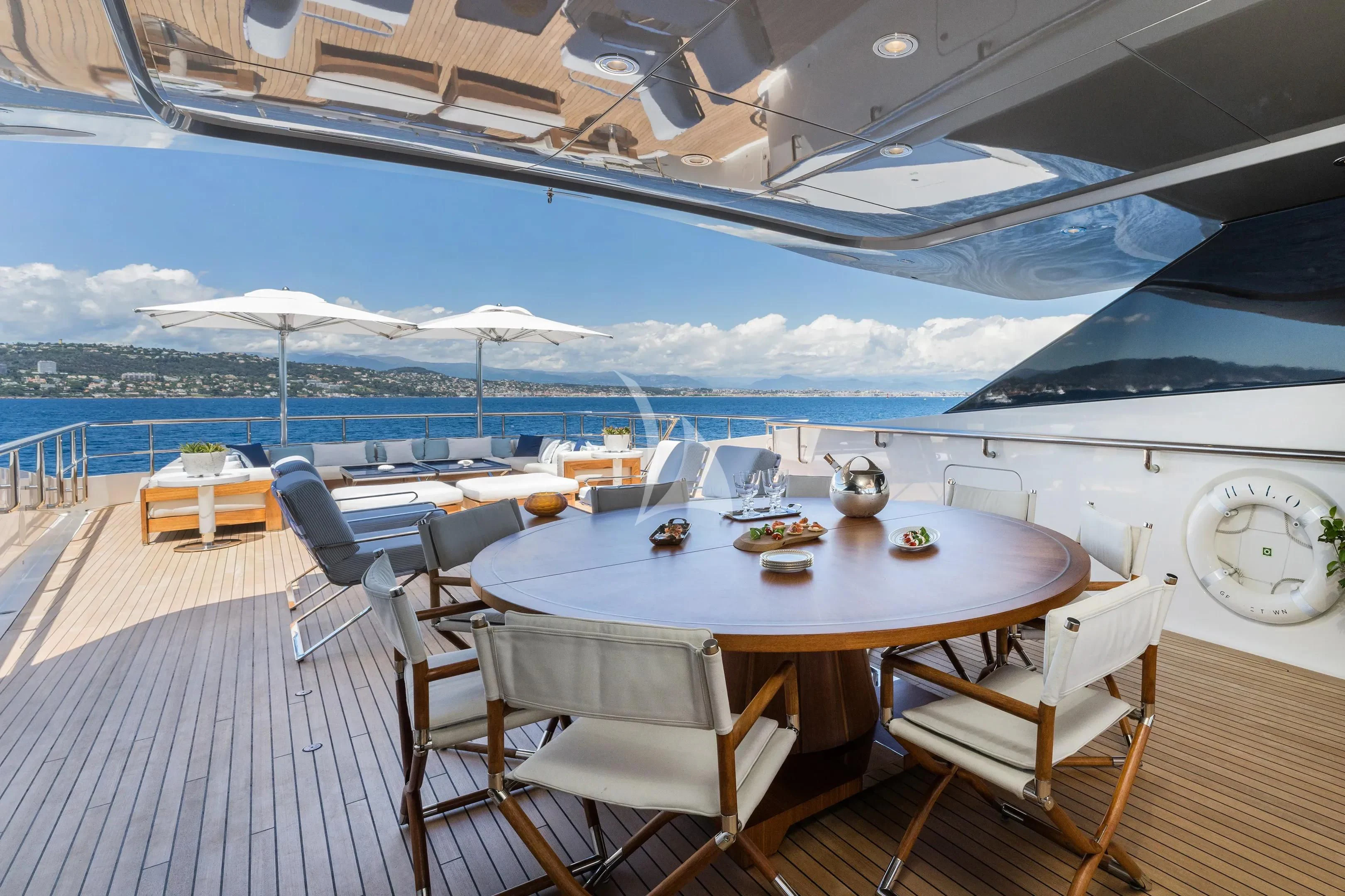 a table set for a meal on a deck overlooking the ocean aboard HALO Yacht for Charter