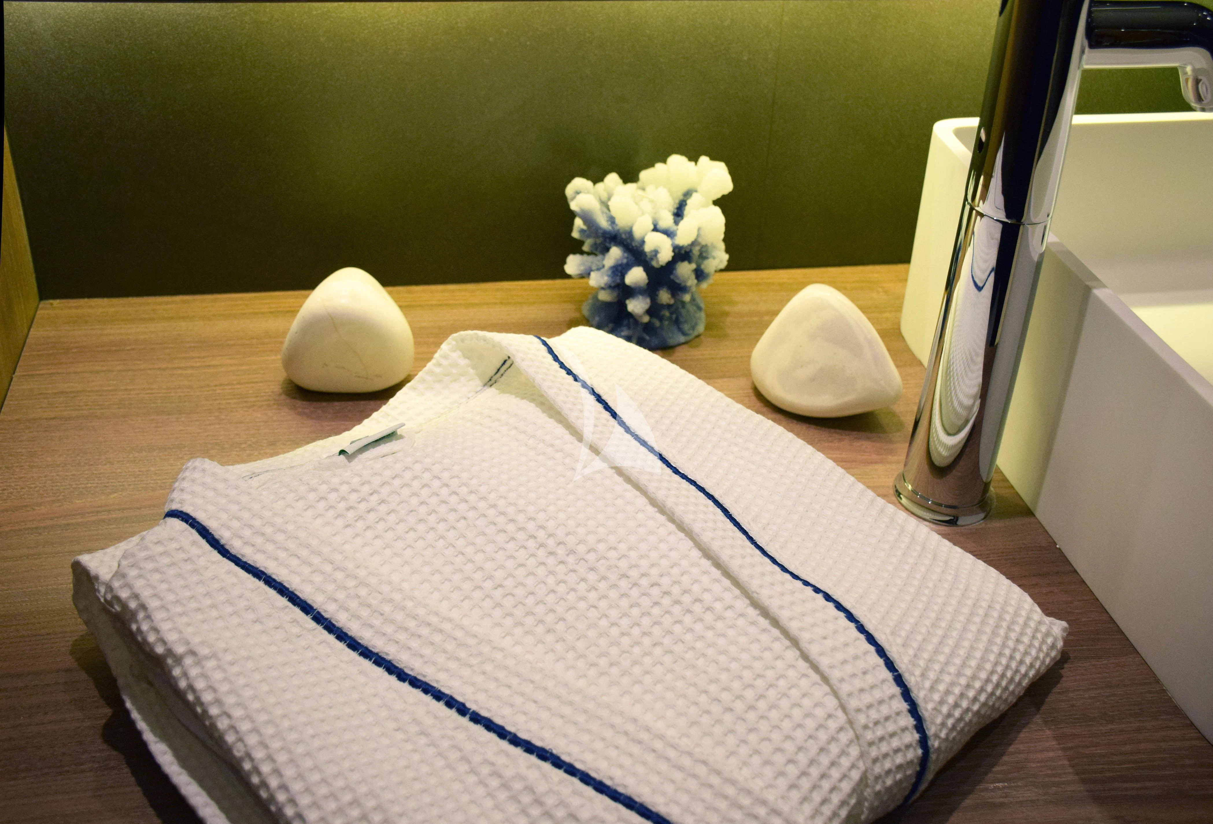 a book and a flower on a table aboard OCEANE II Yacht for Sale