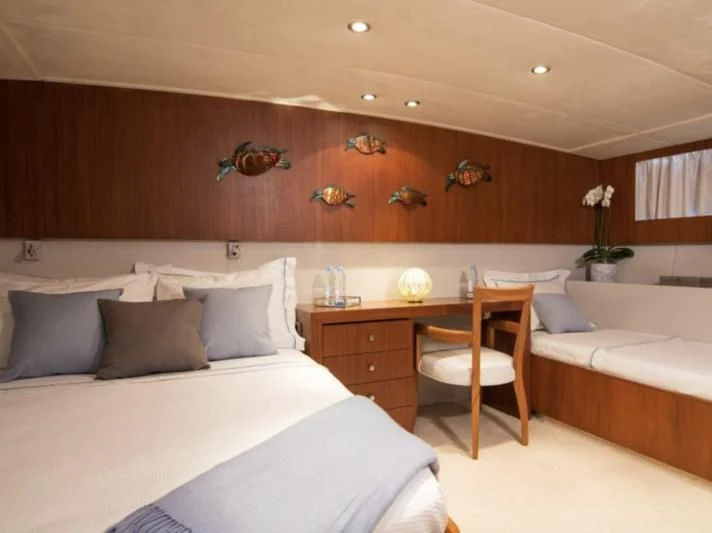 a room with a bed and a desk aboard OCEANE II Yacht for Sale