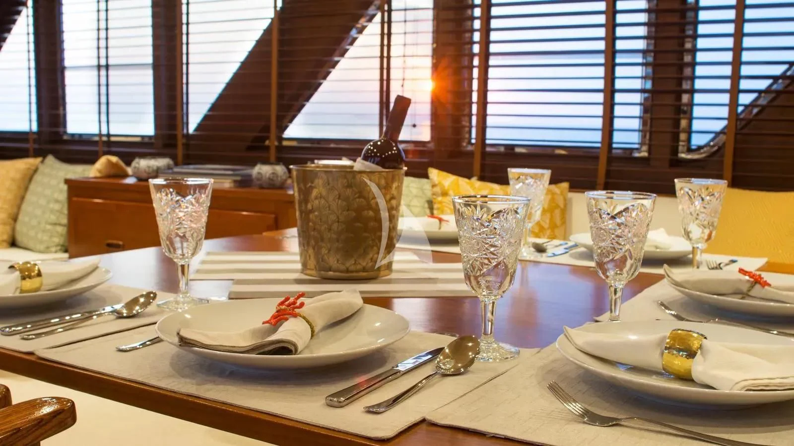 a table with plates and glasses aboard OCEANE II Yacht for Sale
