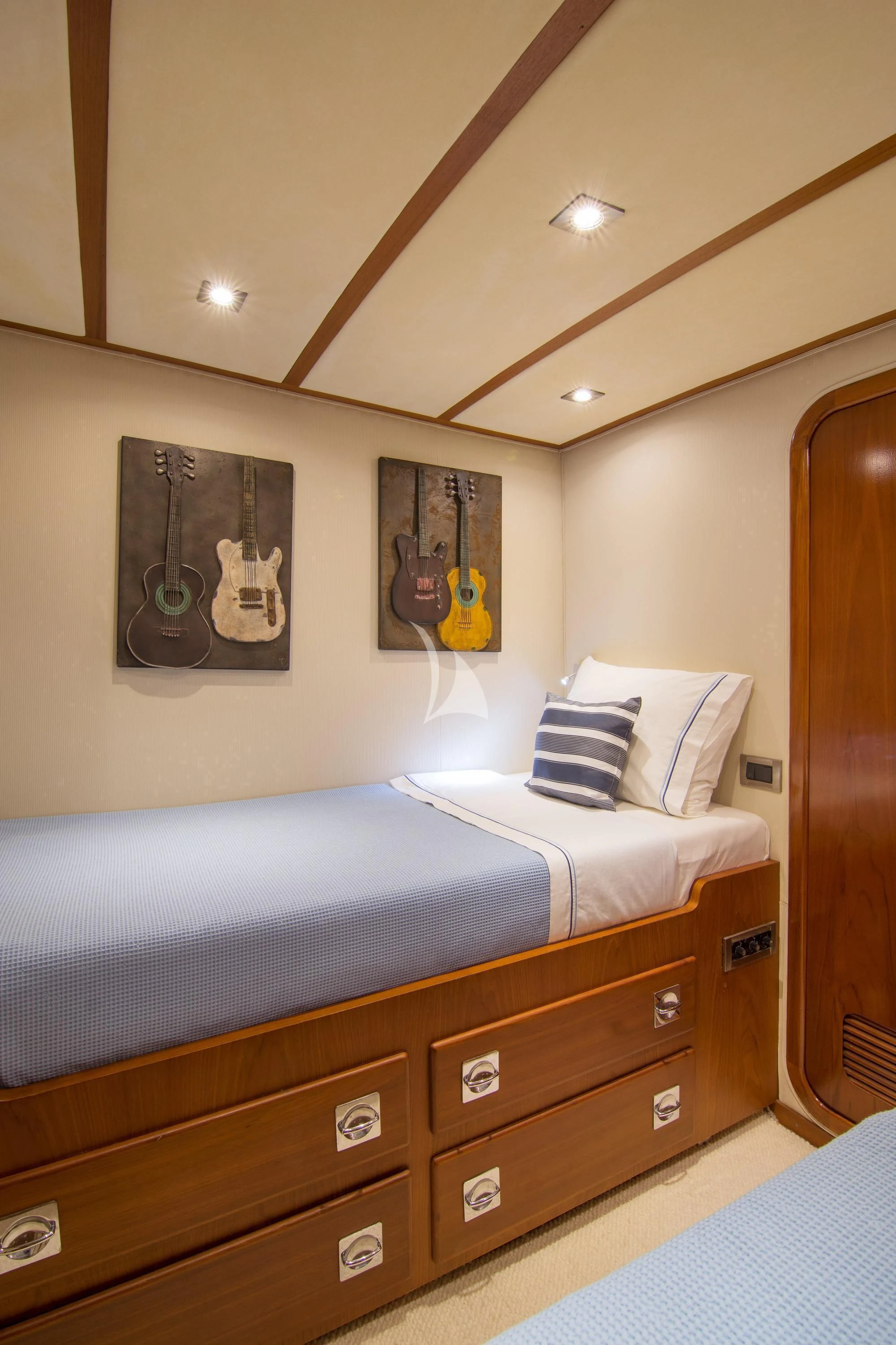 a bedroom with a bed and a wood door aboard OCEANE II Yacht for Sale