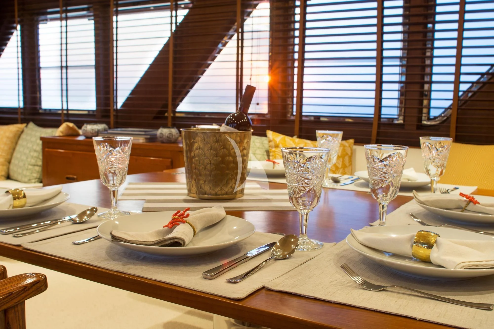 a table with plates and glasses aboard OCEANE II Yacht for Sale