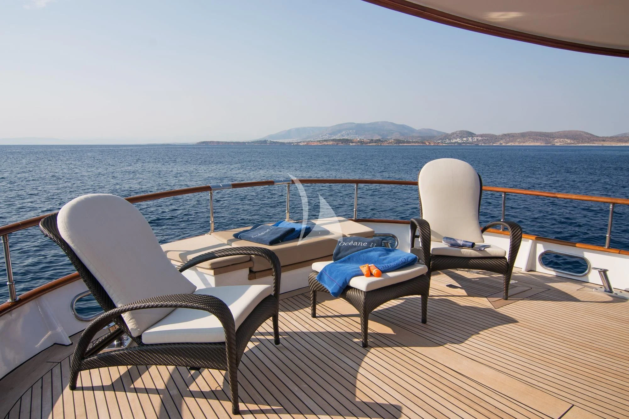a deck with chairs and a table on it aboard OCEANE II Yacht for Sale