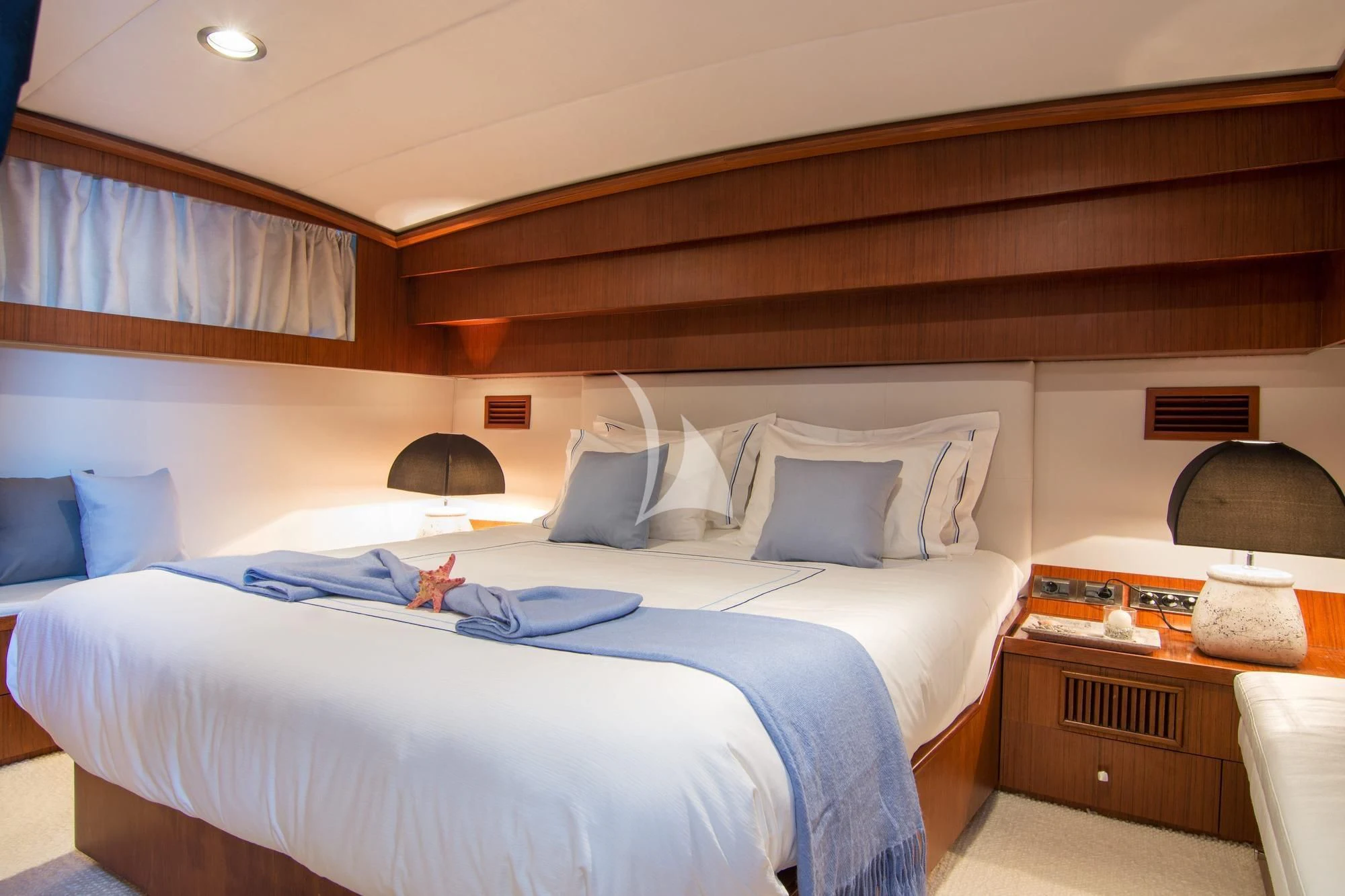 a bed with a blue pillow aboard OCEANE II Yacht for Sale