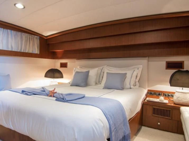 a bed with a white sheet and pillows aboard OCEANE II Yacht for Sale