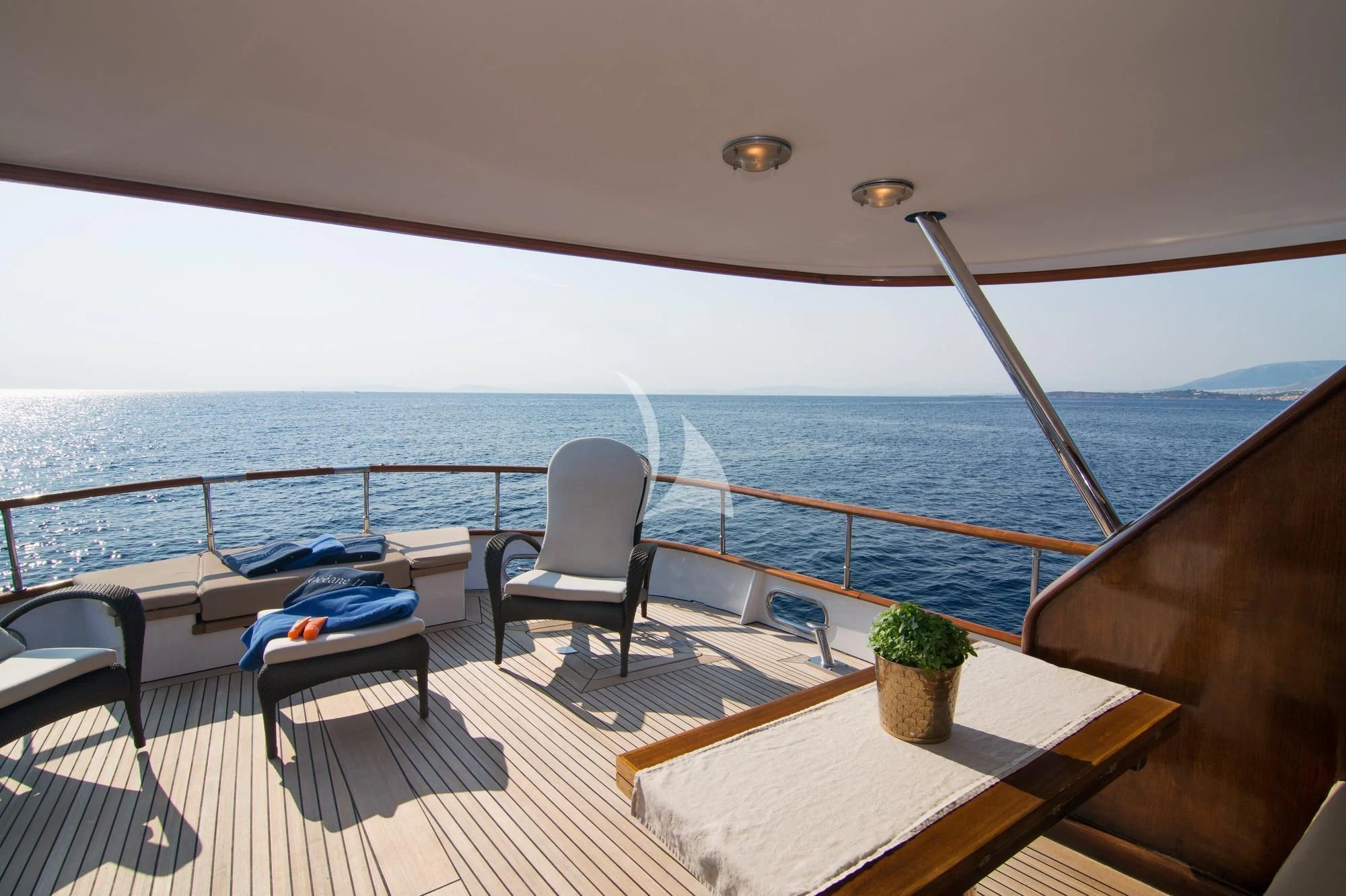 a deck with chairs and a large body of water aboard OCEANE II Yacht for Sale