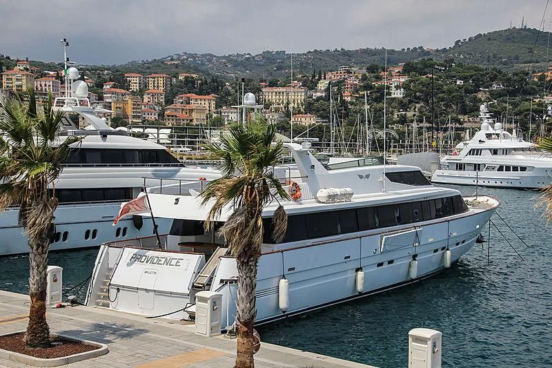 a couple of large boats docked at a pier aboard PROVIDENCE Yacht for Sale