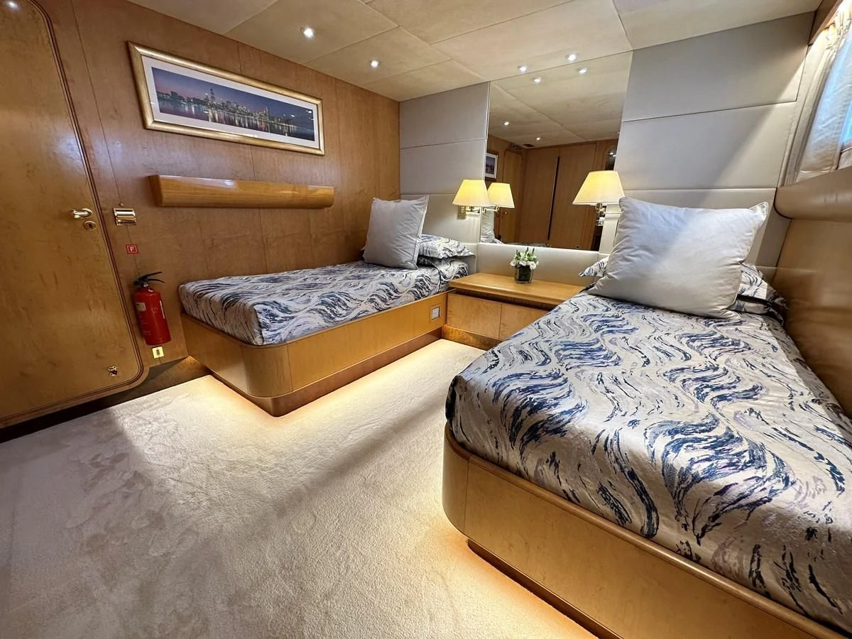 a hotel room with two beds aboard CHEETAH MOON Yacht for Sale