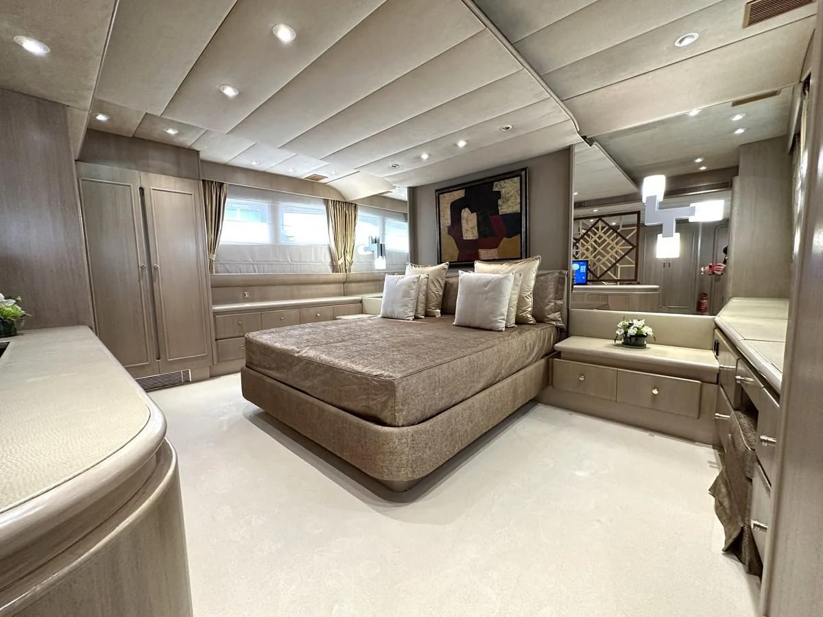a large room with a bed and a desk aboard CHEETAH MOON Yacht for Sale