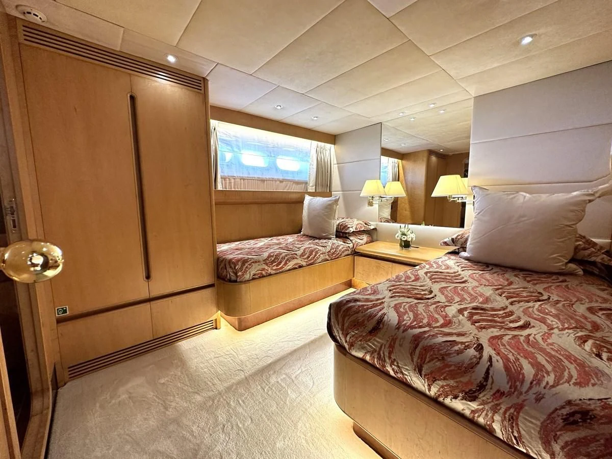 a hotel room with two beds aboard CHEETAH MOON Yacht for Sale