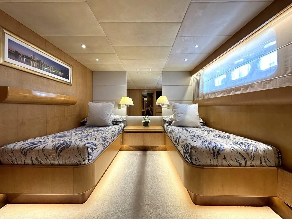 a room with a bed and a desk aboard CHEETAH MOON Yacht for Sale