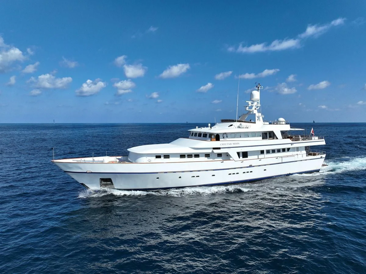 a white yacht in the water aboard CHEETAH MOON Yacht for Sale