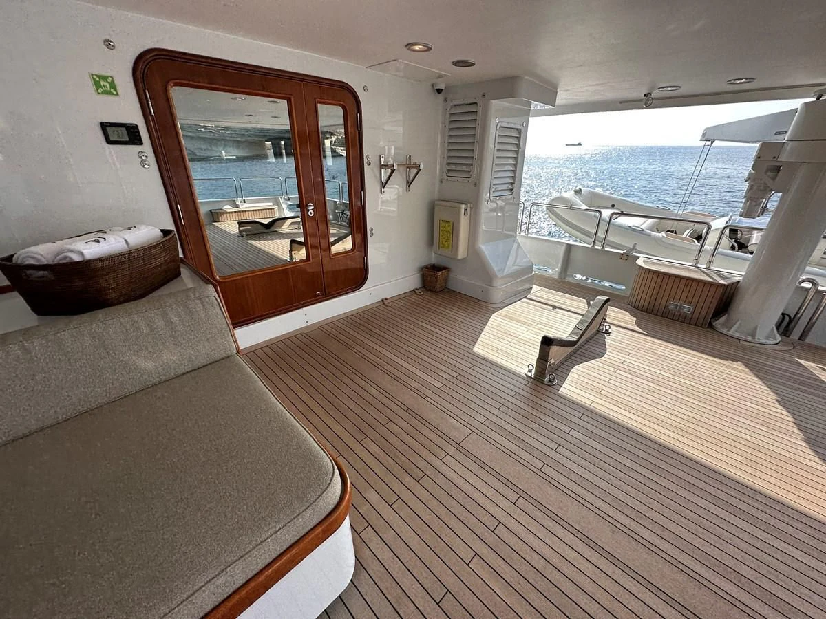 a living room with a large window aboard CHEETAH MOON Yacht for Sale
