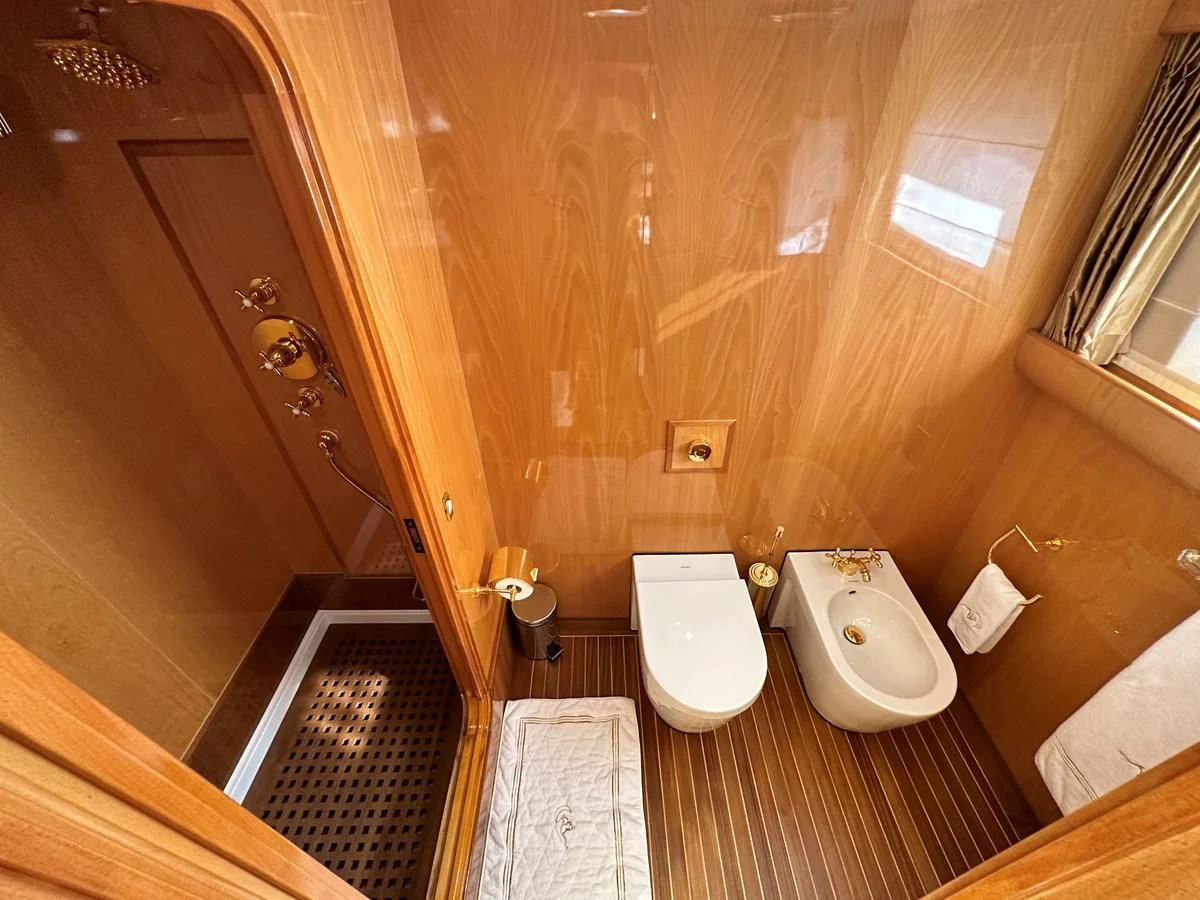 a bathroom with a toilet and a bidet aboard CHEETAH MOON Yacht for Sale