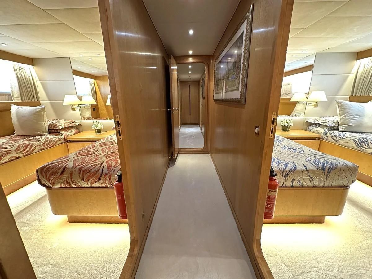 a room with a bed and a closet aboard CHEETAH MOON Yacht for Sale