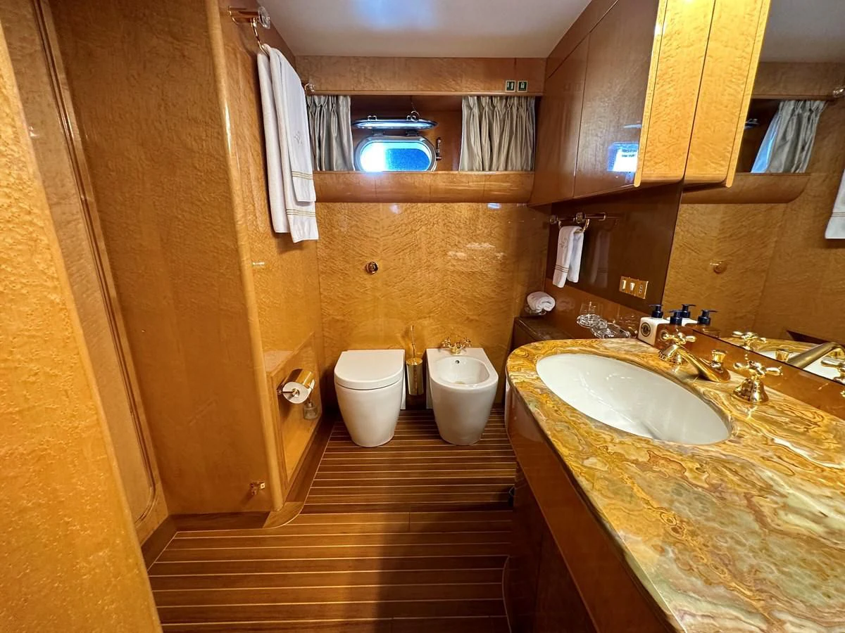 a bathroom with a wood floor aboard CHEETAH MOON Yacht for Sale