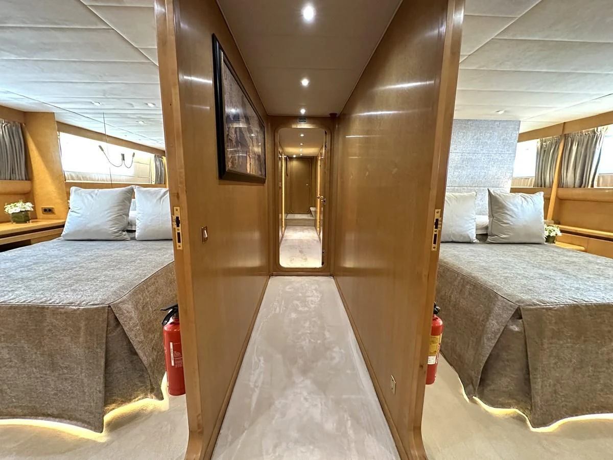 a room with a bed and a door aboard CHEETAH MOON Yacht for Sale