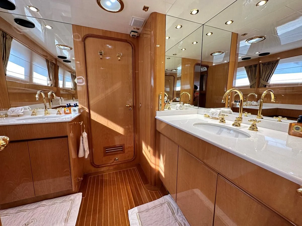 a bathroom with a large mirror aboard CHEETAH MOON Yacht for Sale