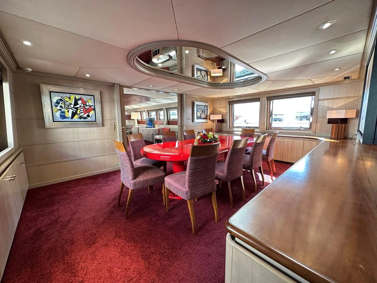 a large room with tables and chairs aboard CHEETAH MOON Yacht for Sale