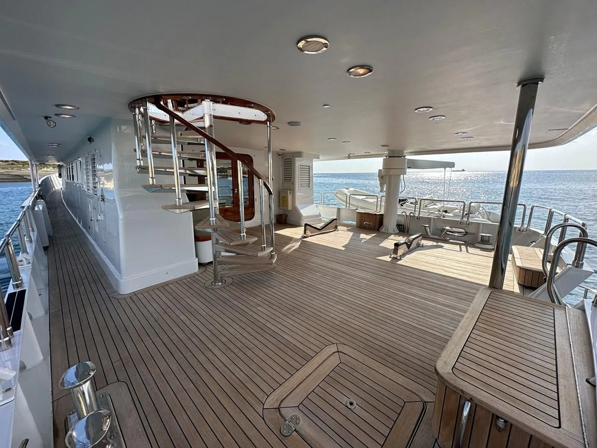 a boat deck with a deck and chairs on it aboard CHEETAH MOON Yacht for Sale