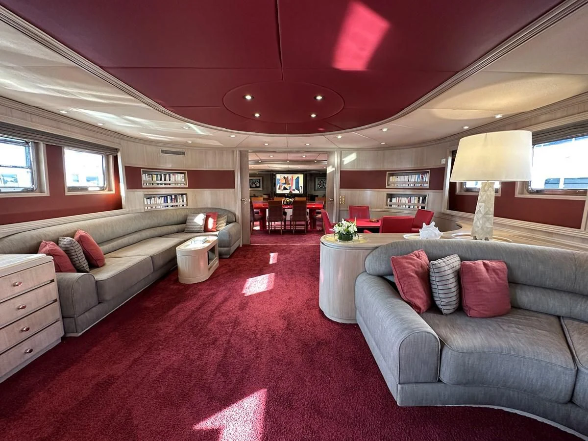 a bedroom with a bed and a couch aboard CHEETAH MOON Yacht for Sale