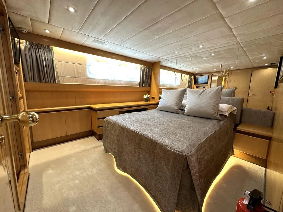 a room with a bed and a couch aboard CHEETAH MOON Yacht for Sale