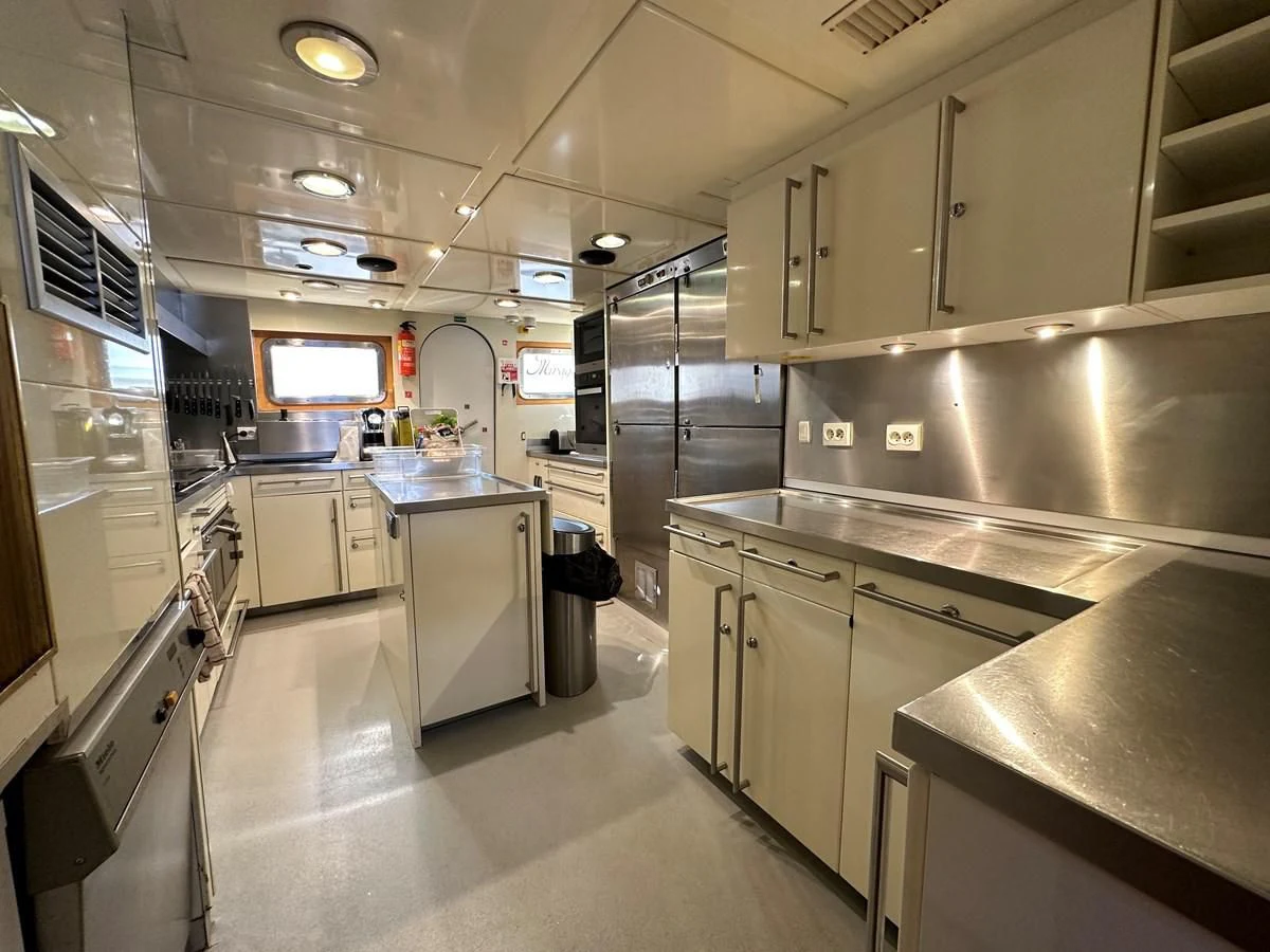 a large kitchen with stainless steel appliances aboard CHEETAH MOON Yacht for Sale