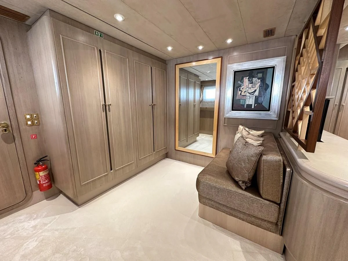 a living room with a couch and a mirror aboard CHEETAH MOON Yacht for Sale