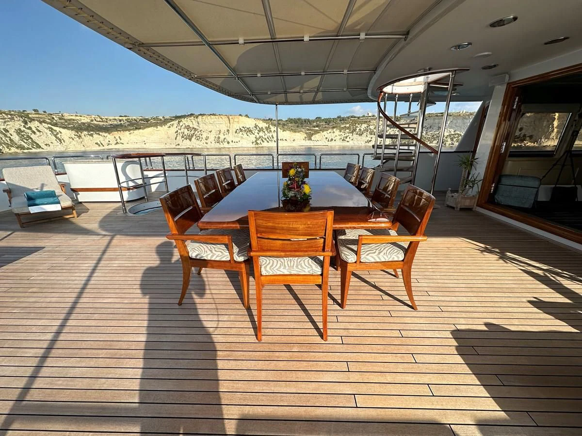 a table and chairs on a deck aboard CHEETAH MOON Yacht for Sale