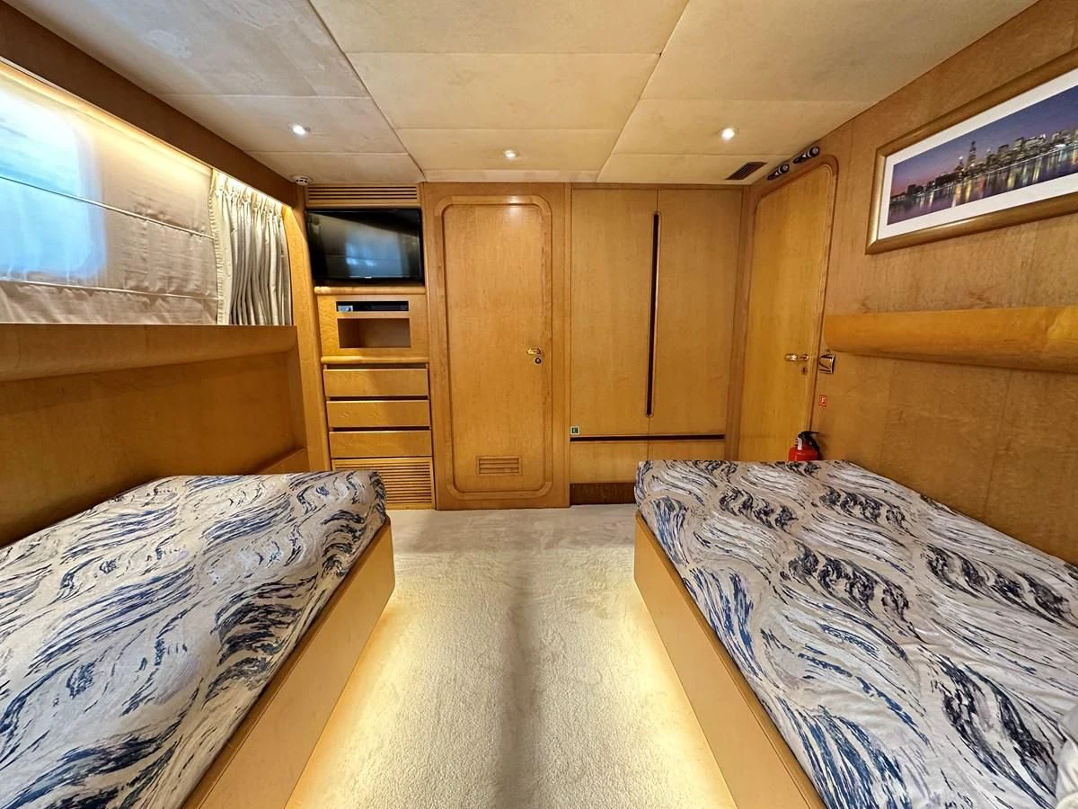 a room with a bed and a tv aboard CHEETAH MOON Yacht for Sale