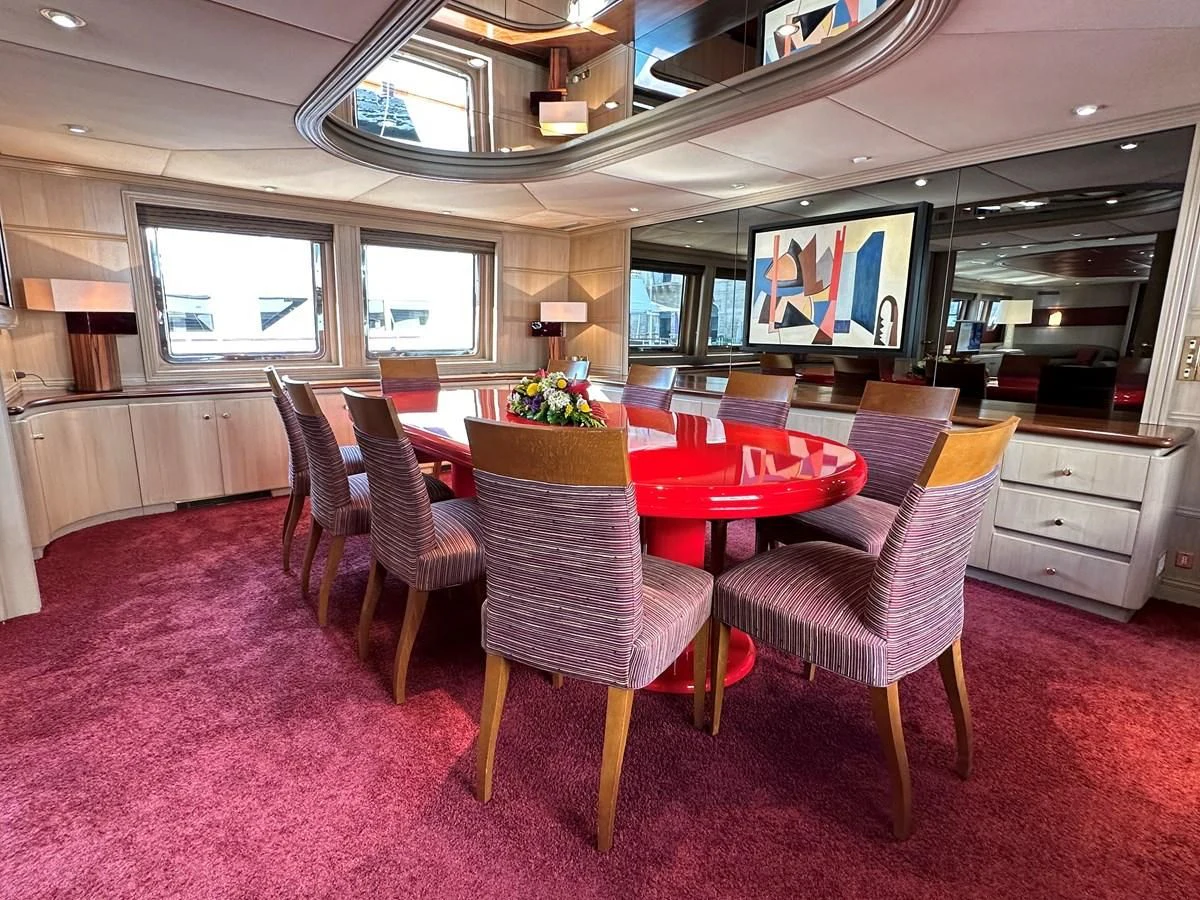 a room with a table chairs and a tv aboard CHEETAH MOON Yacht for Sale