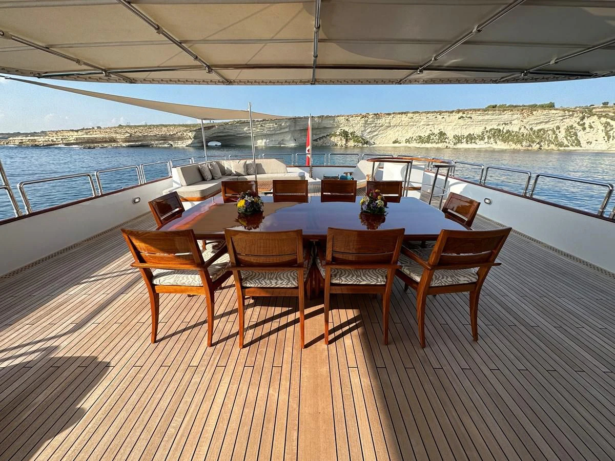 a table on a deck aboard CHEETAH MOON Yacht for Sale