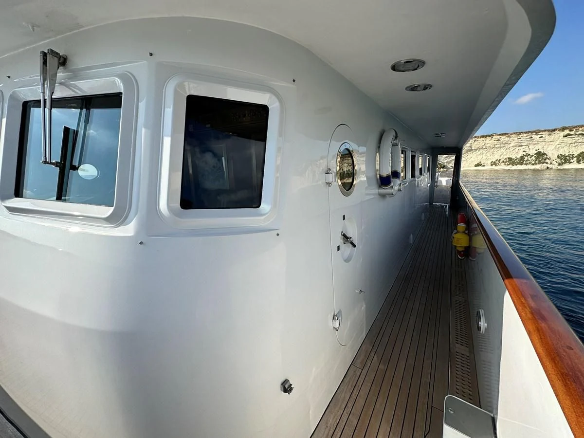 a white vehicle on a dock aboard CHEETAH MOON Yacht for Sale
