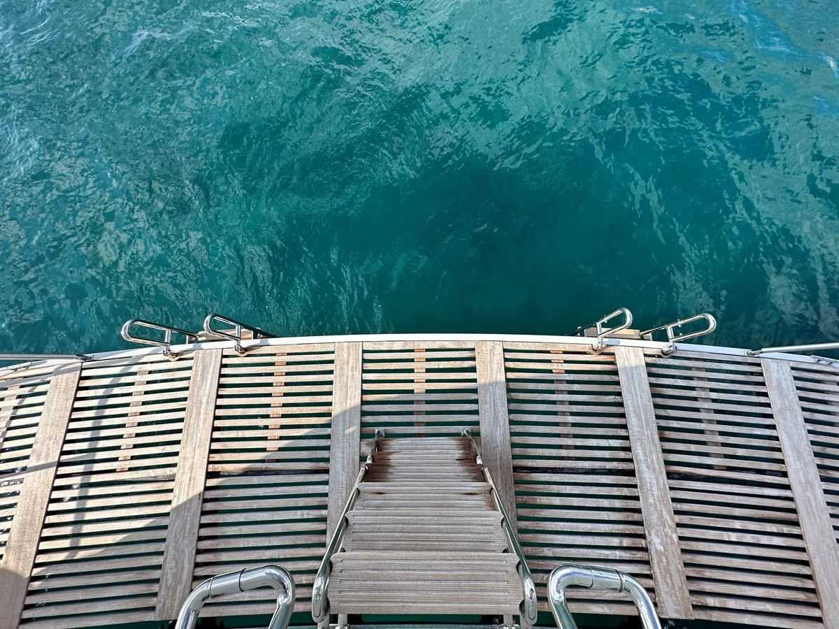 a dock with a railing and a body of water in the background aboard CHEETAH MOON Yacht for Sale