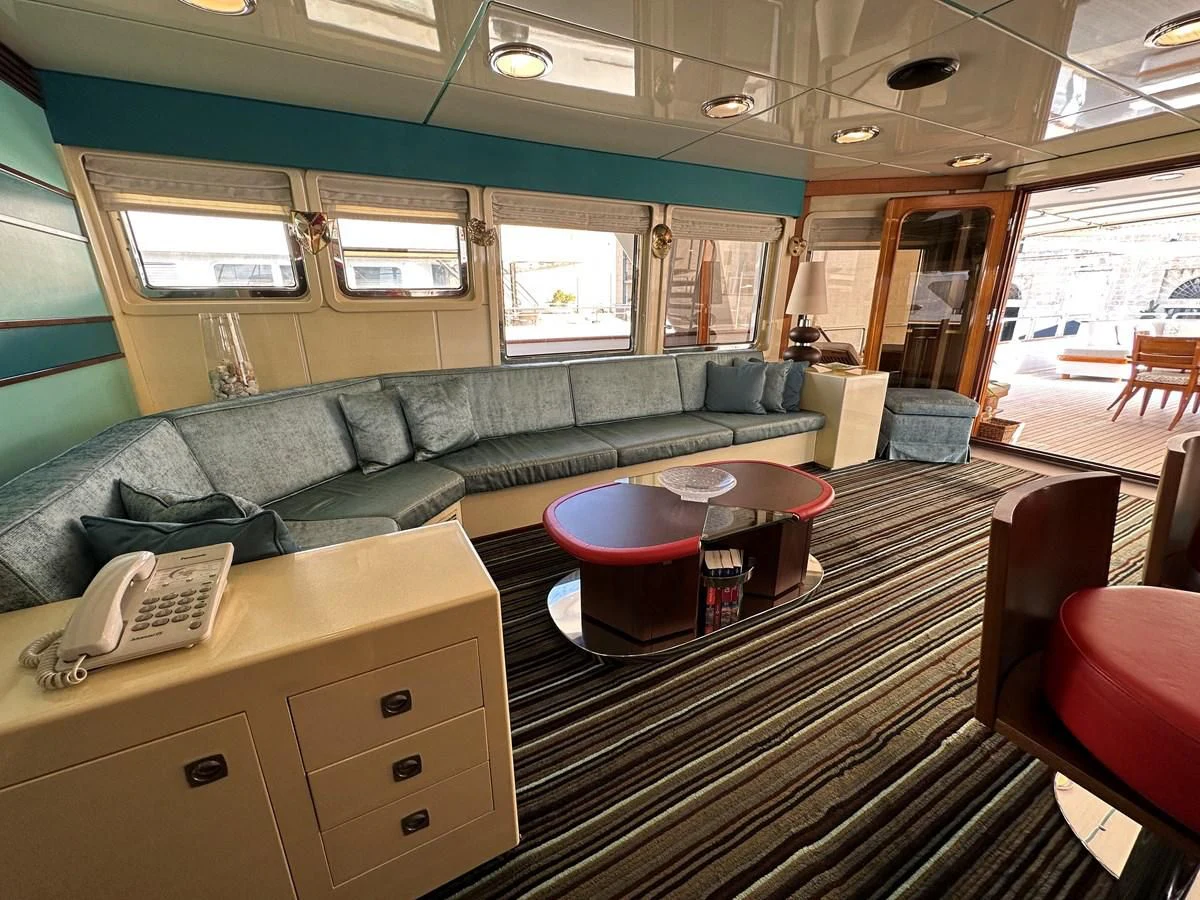 a living room with a couch and a coffee table aboard CHEETAH MOON Yacht for Sale