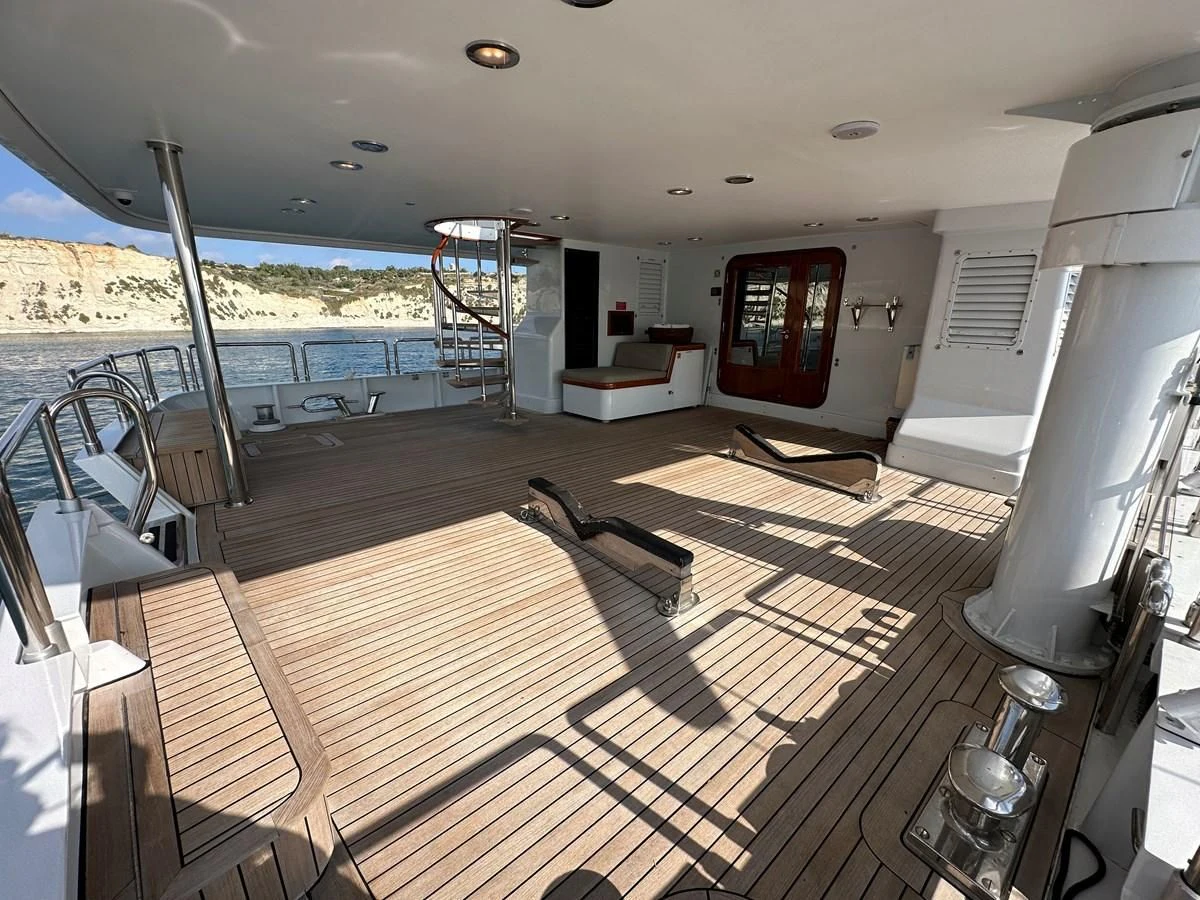 a deck with a deck and a view of the water aboard CHEETAH MOON Yacht for Sale