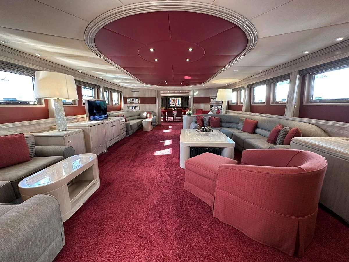 a living room with a red carpet aboard CHEETAH MOON Yacht for Sale