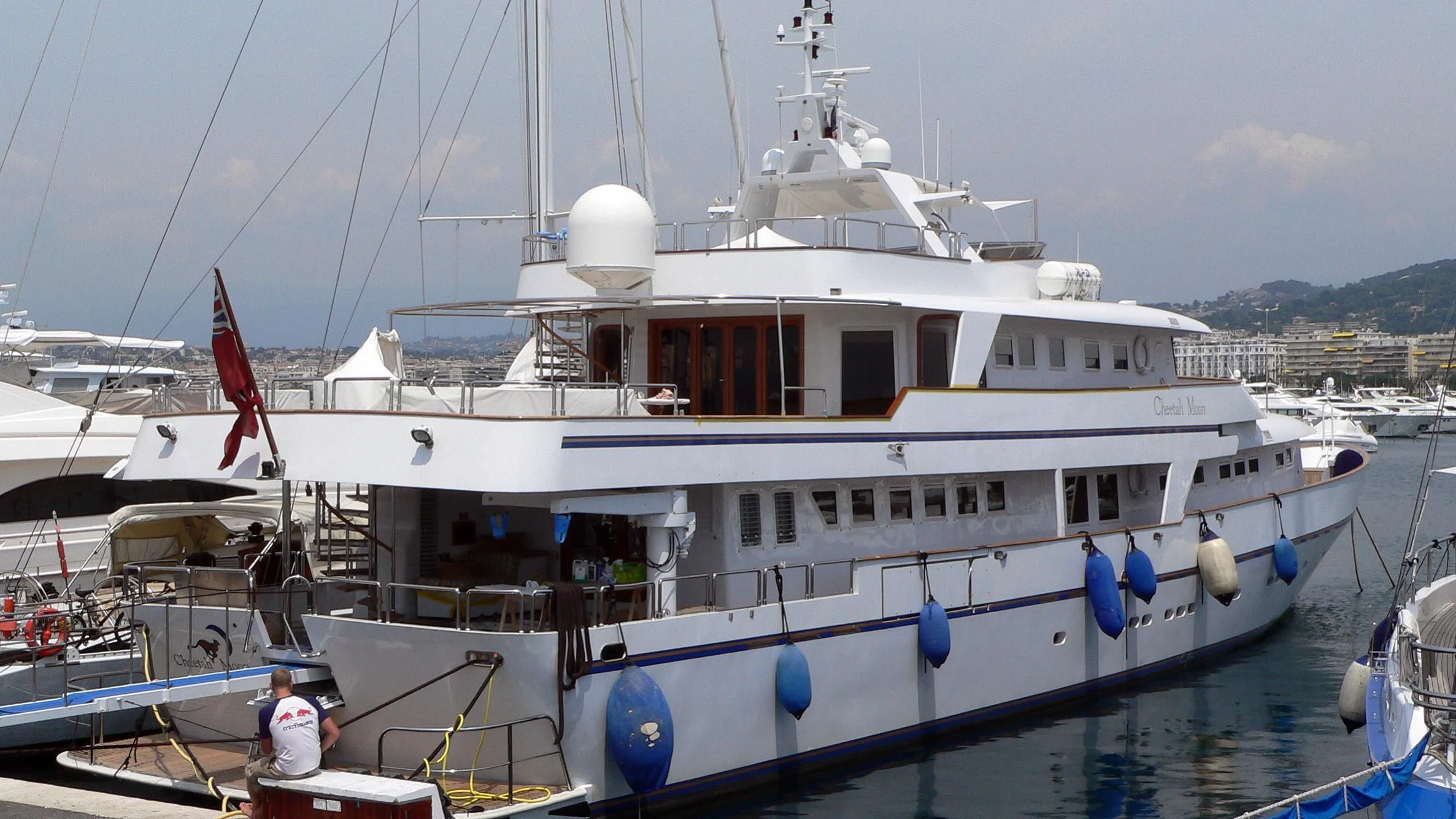 a large white boat with a person standing on the deck aboard CHEETAH MOON Yacht for Sale