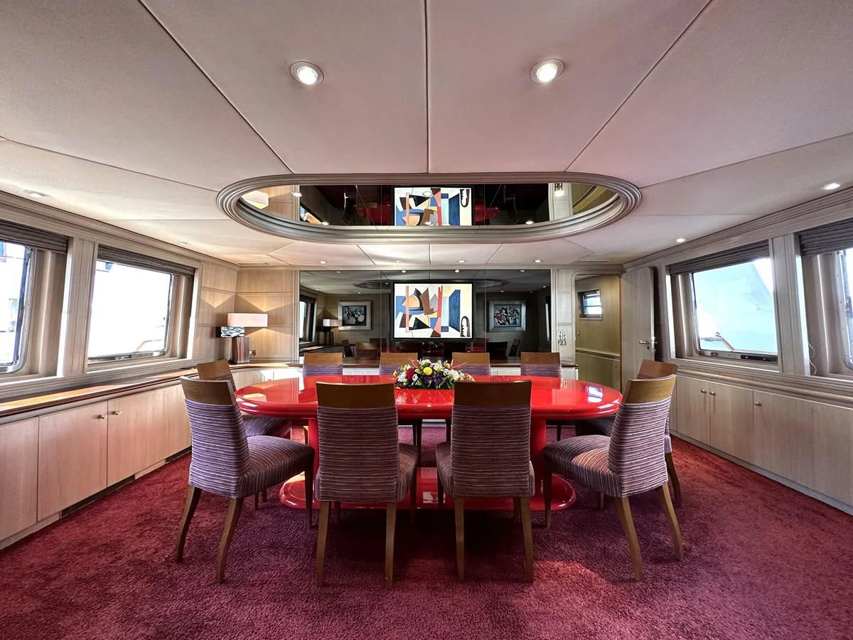 a dining room with a table and chairs aboard CHEETAH MOON Yacht for Sale