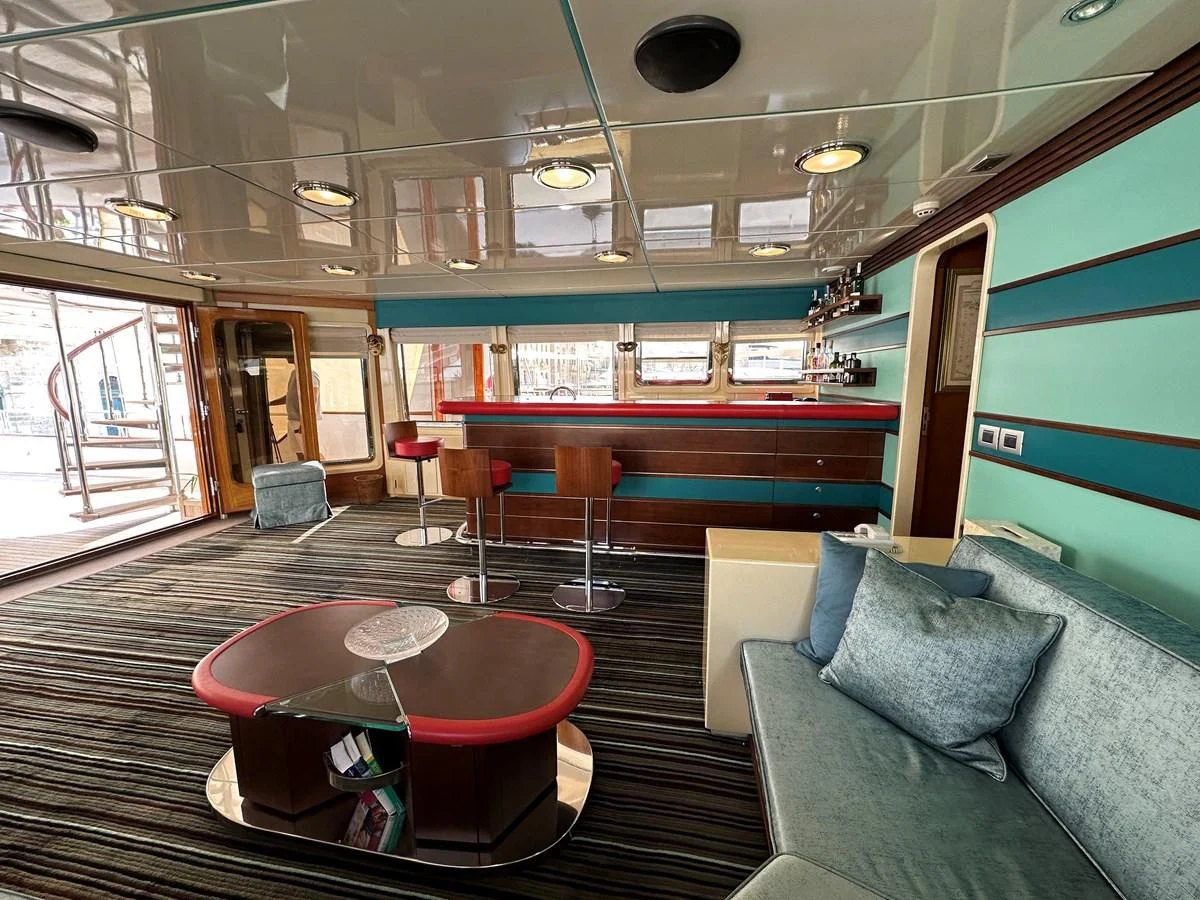 a room with a couch and a table aboard CHEETAH MOON Yacht for Sale