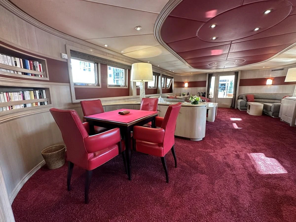 a room with a table and chairs aboard CHEETAH MOON Yacht for Sale