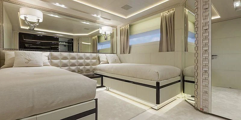 a room with a bed and a couch aboard PARILLION Yacht for Sale