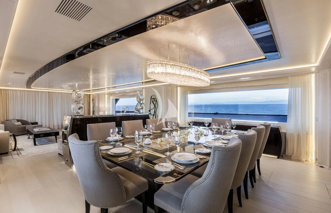 a dining room with a large chandelier aboard PARILLION Yacht for Sale